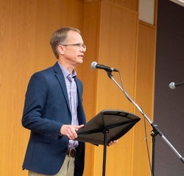 Paul Heidebrecht speaking into a microphone