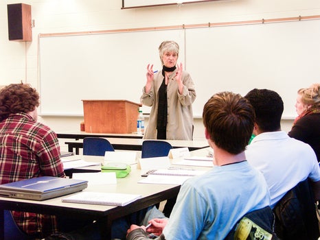 Hildi Froese Tiessen standing at front of class teaching students