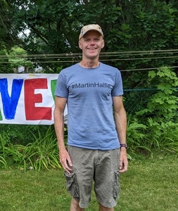 David Martin standing infront of greenery