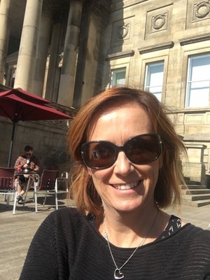 deb neills selfie in front of building