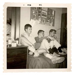 Ed Harder and two friends sitting on bed 