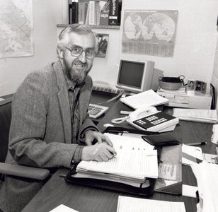 Ernie Regehr sitting at his desk 