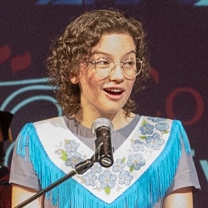 Hanne standing at a microphone 