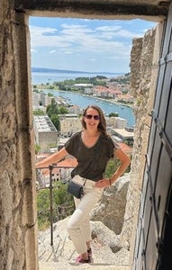 Marta Van Zanten posing in doorway above a city view
