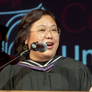 Mollee standing at microphone