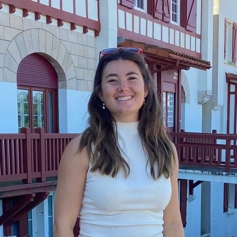 A woman student smiles