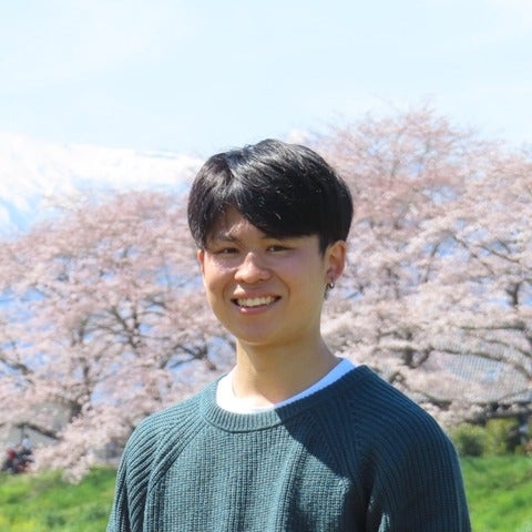 A man in front of cherry blossoms