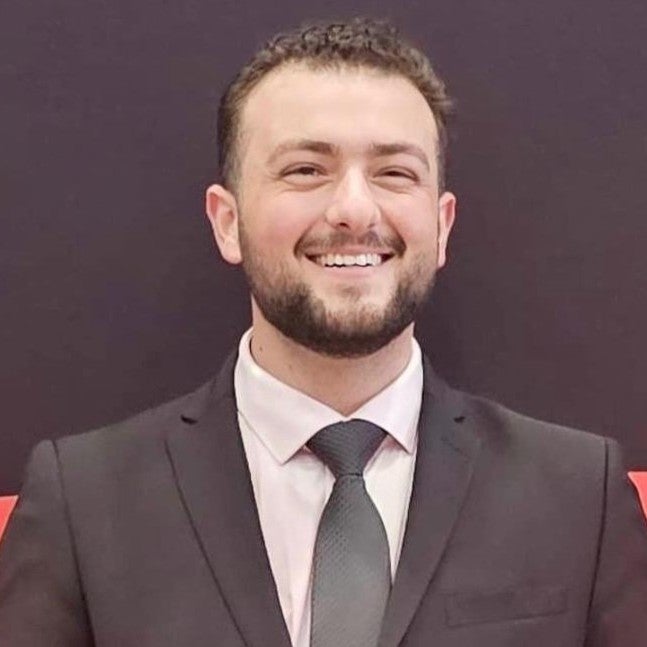 a man in suit smiles