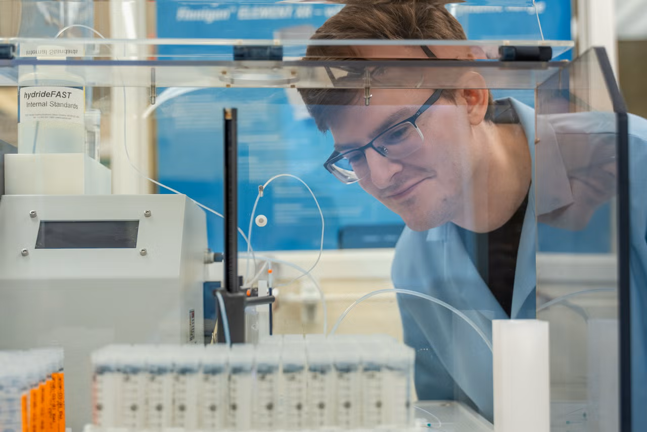Kevin White, a PhD candidate, looking at his samples run while conducting research.