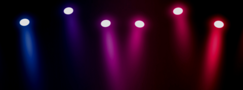 blue, purple, and red spotlights over a dark stage