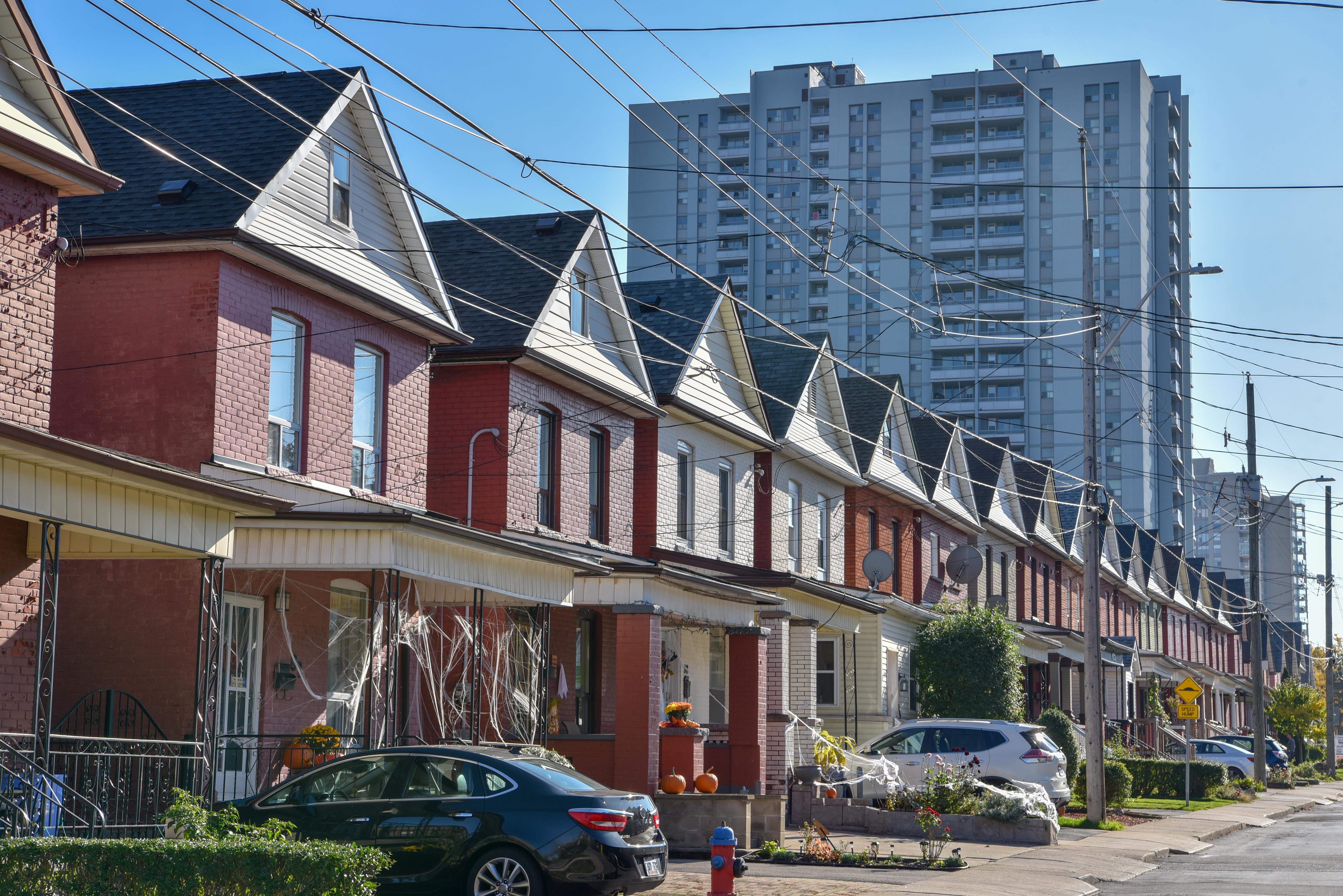 Row of early 20th century homes with sun shining off façade 