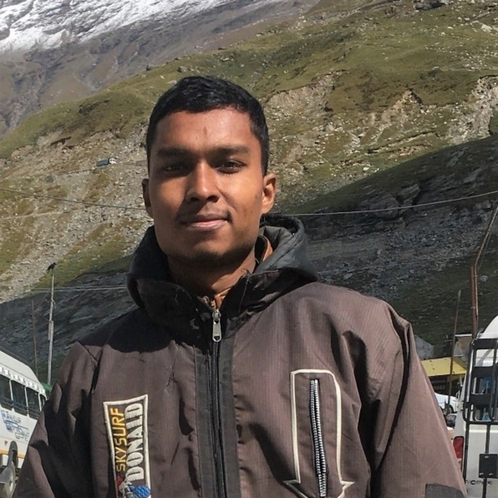 Punit standing in front of mountains