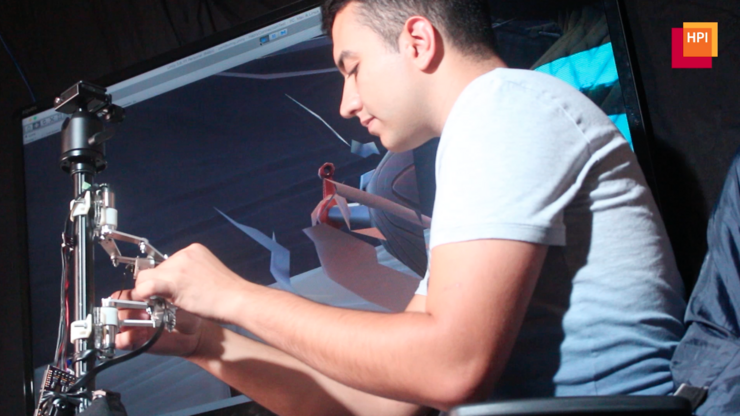 Someone who is blind playing a first-person shoort video game using a haptic device