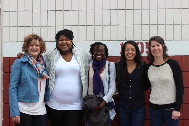 A photo of lab members standing and smiling.