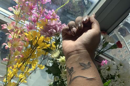 Wrist tattoo of birds carrying a branch