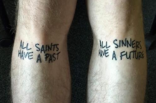 Tattoo under knees, reads 