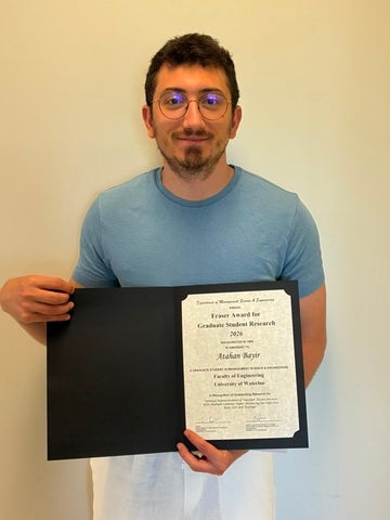 Atahan Bayir holding the Fraser Award Plaque