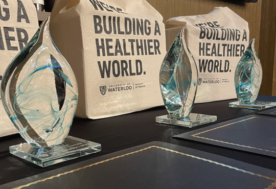 Achievement awards crystal statuettes and building a healthier world gift bags.