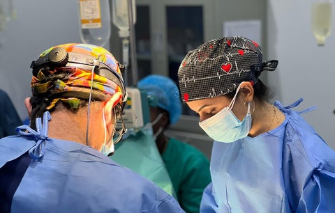 Dr. Jivani-Tajdin and colleague performing surgery in an operating room.