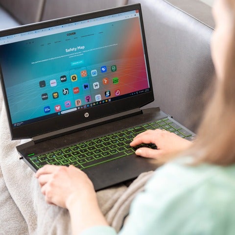 Woman looks at Coder Safety Map app on a laptop screen.