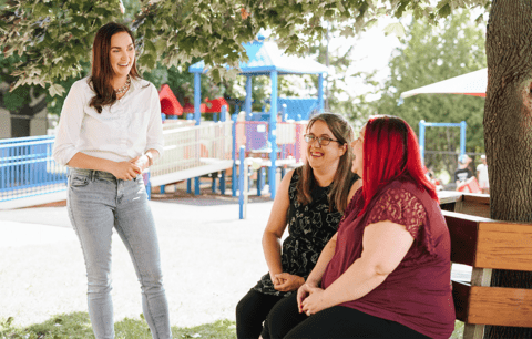 Taryn Eickmeier speaks with parents at children's playground.