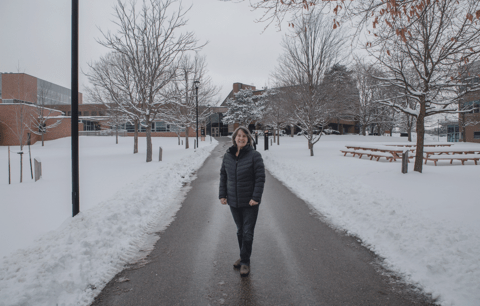 Caroline Wiley stands on campus' alumni path leading to B.C. Matthews Hall.