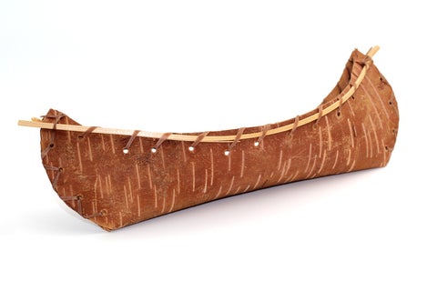 Small canoe with a birch bark hull and wooden gunnels.
