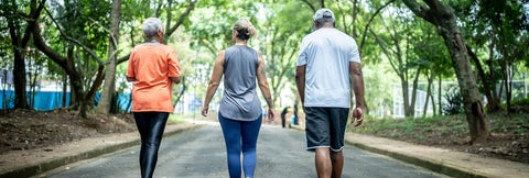 Three people walking in the park.