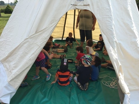 Kids huddled in tipi