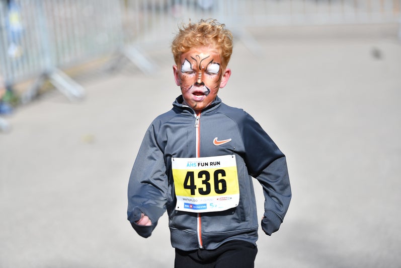 Child with face paint running