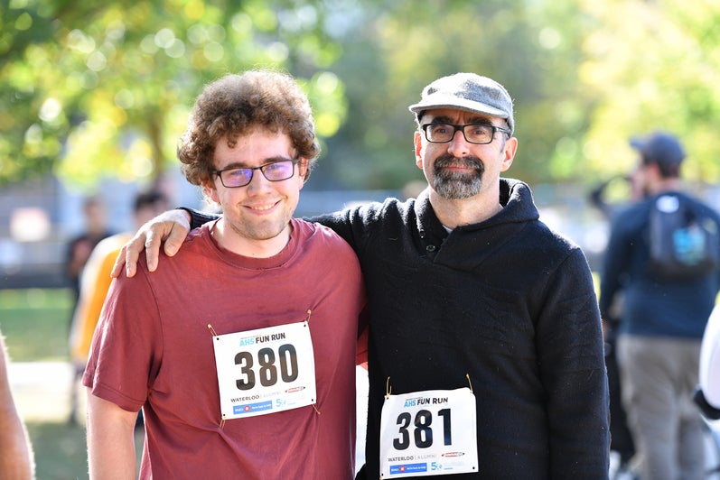 Two male Fun Run participants smiling at the camera