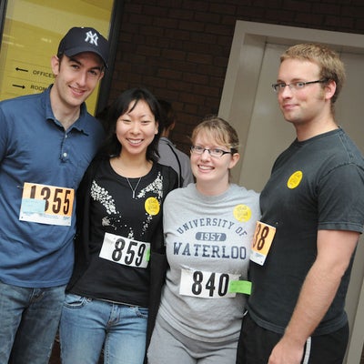 Four participants for the race smiling towards the camera