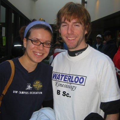 A man and woman both wearing University of Waterloo related T-shirts.