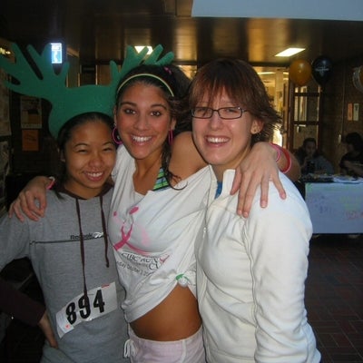 Three female runners inside a building before the race.