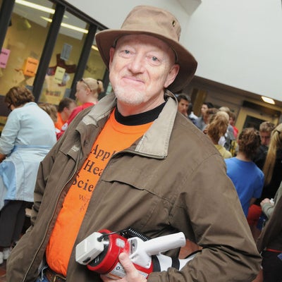 A man holding a megaphone in front of registrar's desk