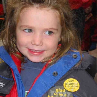 A girl smiling with two University of Waterloo badges on her jacket