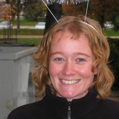 A female with a halo-like headband smiling towards the camera