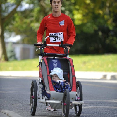 Runner number 34 running with his baby in a baby stroller 