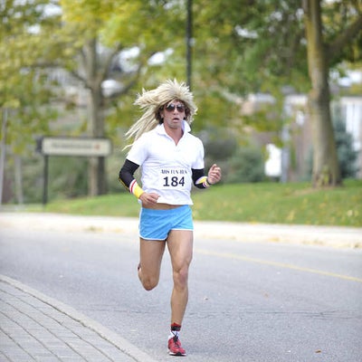 A man with a wig running towards camera