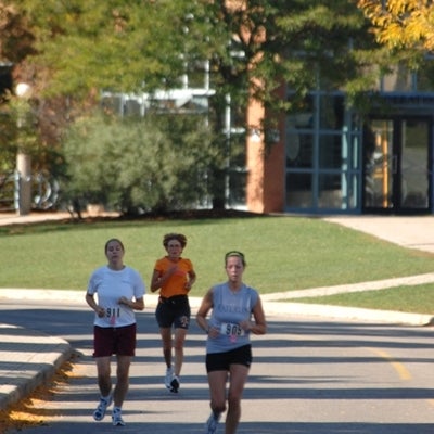 Three female runners running 
