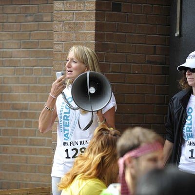 A woman holding a megaphone talking to the crowd
