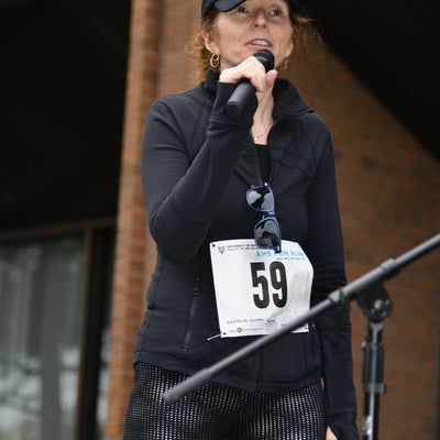 Woman speaking into a microphone.