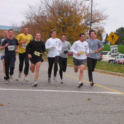 Eight runners running down the road