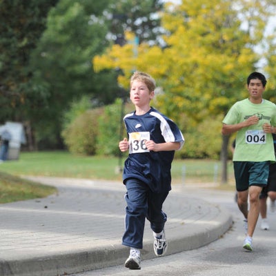 A boy running down the road