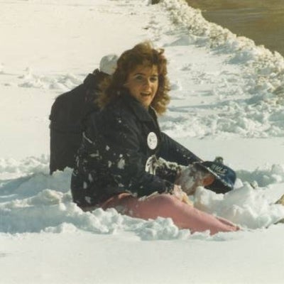 A female participant sitting on snow