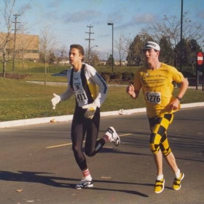 Two male participants running on campus road