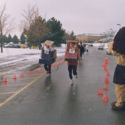 Two participants running in box-made costumes.