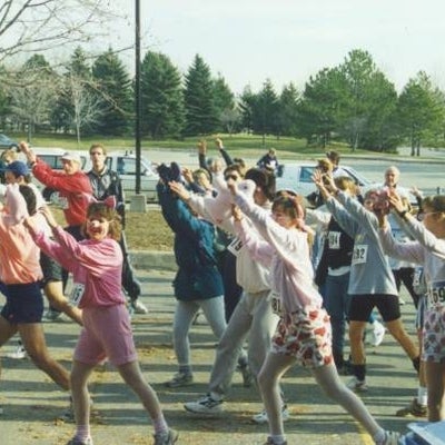 Participants wearing costumes stretching before the race.