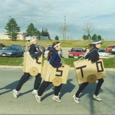 Four girls in train costume designed with four boxes attatched with strings