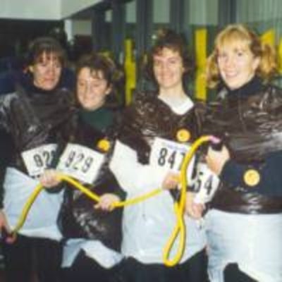 Four females holding a yellow rope.